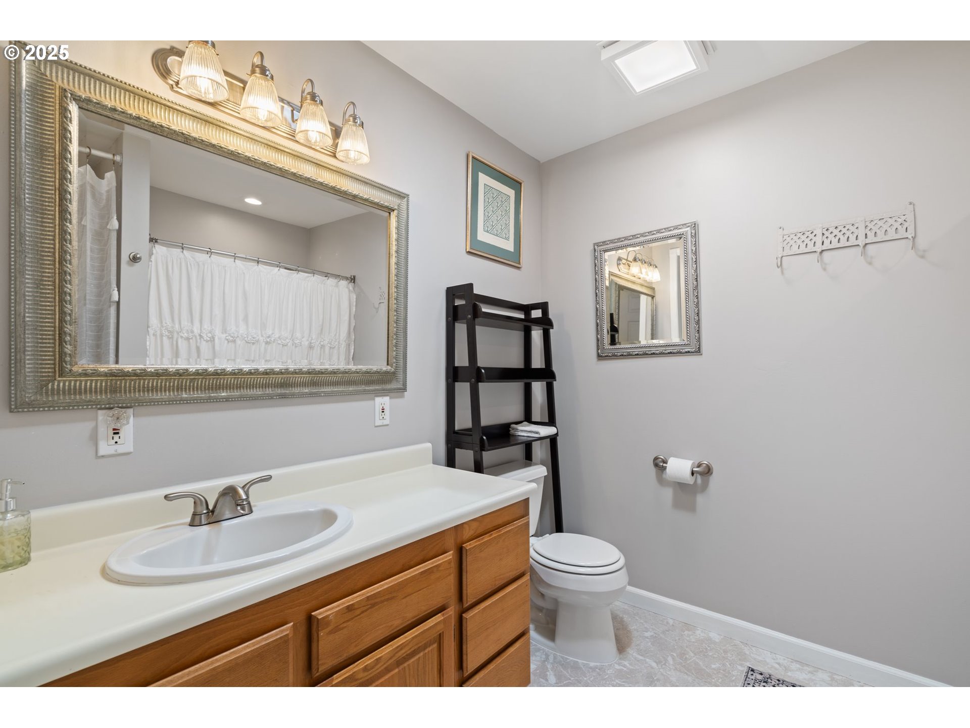 4517 Northeast 85th Avenue Portland, OR 97220 - Photo 18 of 38 a bathroom with a toilet a sink and mirror