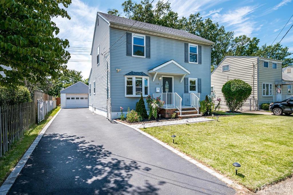 a view of a house with backyard and sitting area