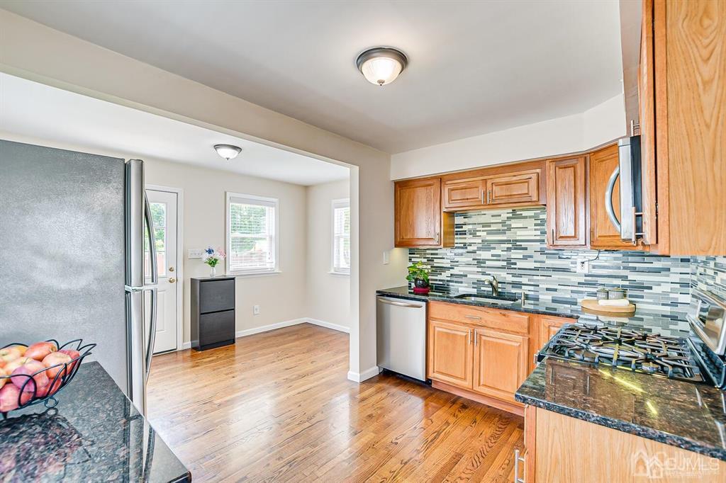 119 Wagner Street Edison, NJ 08837 - Photo 12 of 41 a kitchen with stainless steel appliances granite countertop a stove a sink and a refrigerator