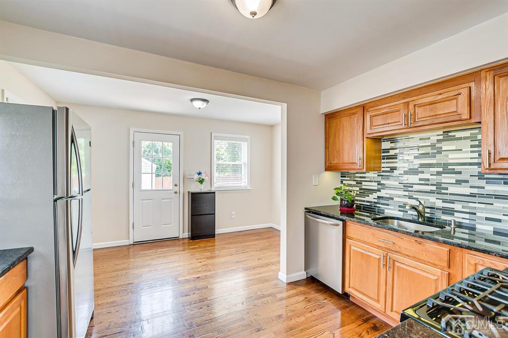 119 Wagner Street Edison, NJ 08837 - Photo 13 of 41 a kitchen with stainless steel appliances granite countertop a refrigerator a stove a sink and dishwasher with wooden floor