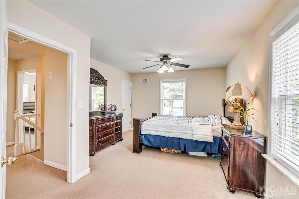 119 Wagner Street Edison, NJ 08837 - Photo 24 of 41 a spacious bedroom with a bed and a chandelier