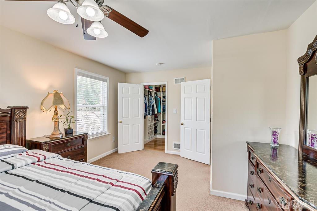 119 Wagner Street Edison, NJ 08837 - Photo 26 of 41 a bedroom with a bed and a chandelier