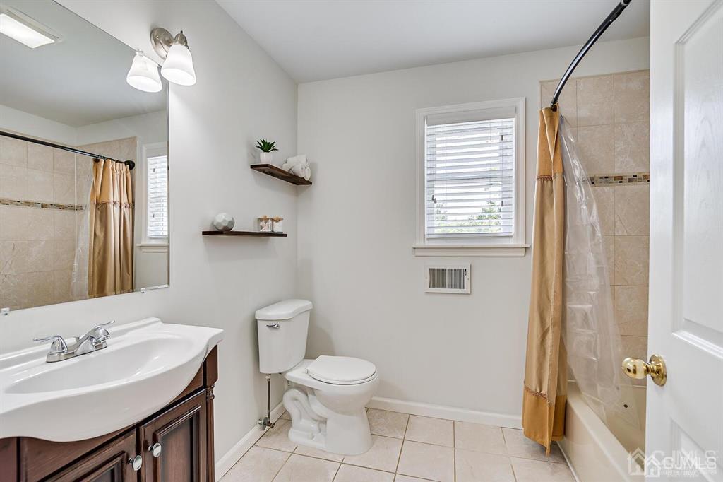 119 Wagner Street Edison, NJ 08837 - Photo 28 of 41 a bathroom with a toilet a sink and mirror