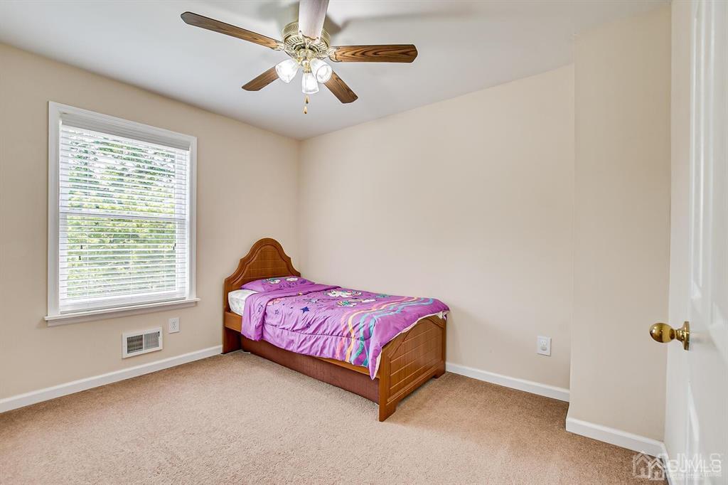 119 Wagner Street Edison, NJ 08837 - Photo 31 of 41 a spacious bedroom with a bed and a chandelier