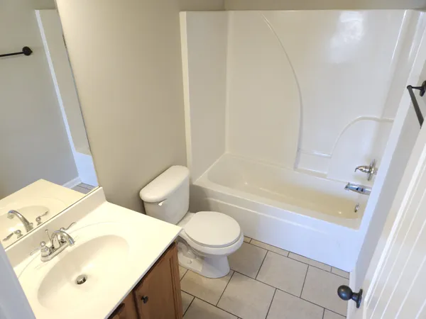 a bathroom with a sink a toilet and a bathtub