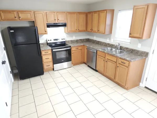 a kitchen with a sink a stove and refrigerator