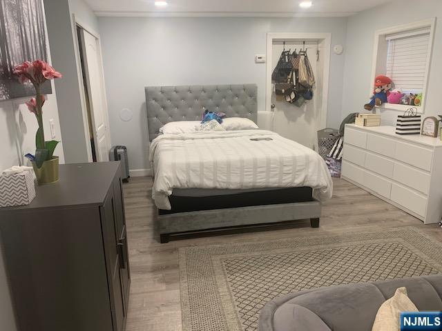 414 7th Street Fairview, NJ 07022 - Photo 3 of 6 a bedroom with a bed and a dresser