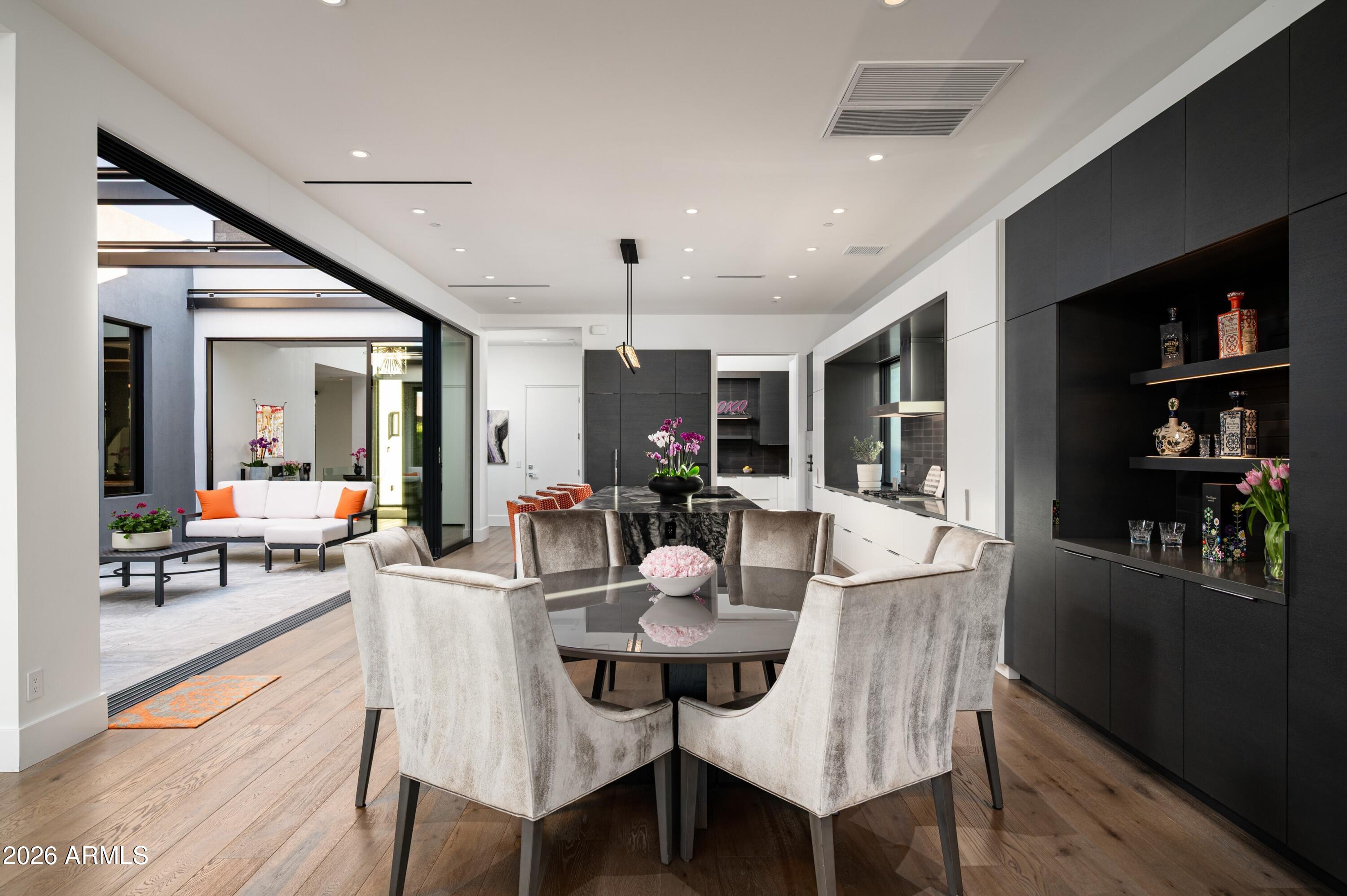 6914 East Cactus Wren Road Paradise Valley, AZ 85253 - Photo 12 of 38 a view of a dining room with furniture and wooden floor
