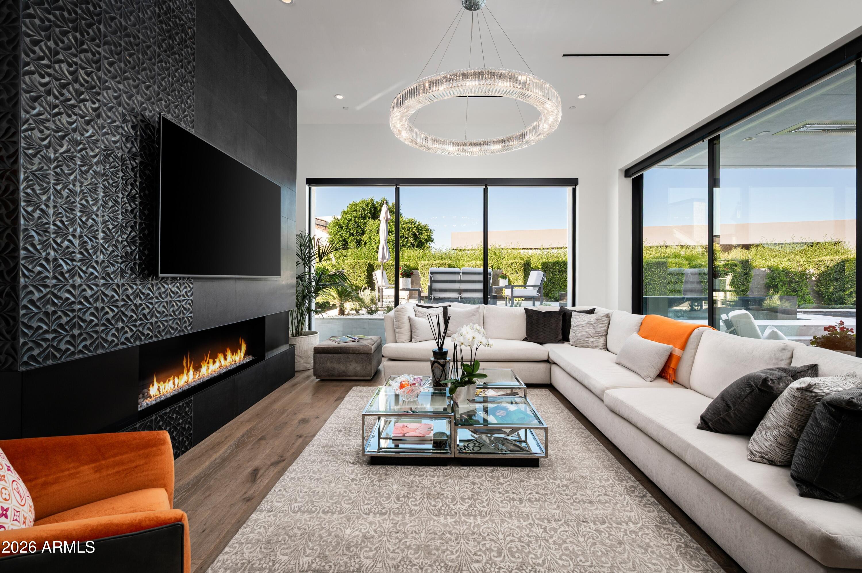 6914 East Cactus Wren Road Paradise Valley, AZ 85253 - Photo 13 of 38 a living room with furniture flat screen tv and a large window