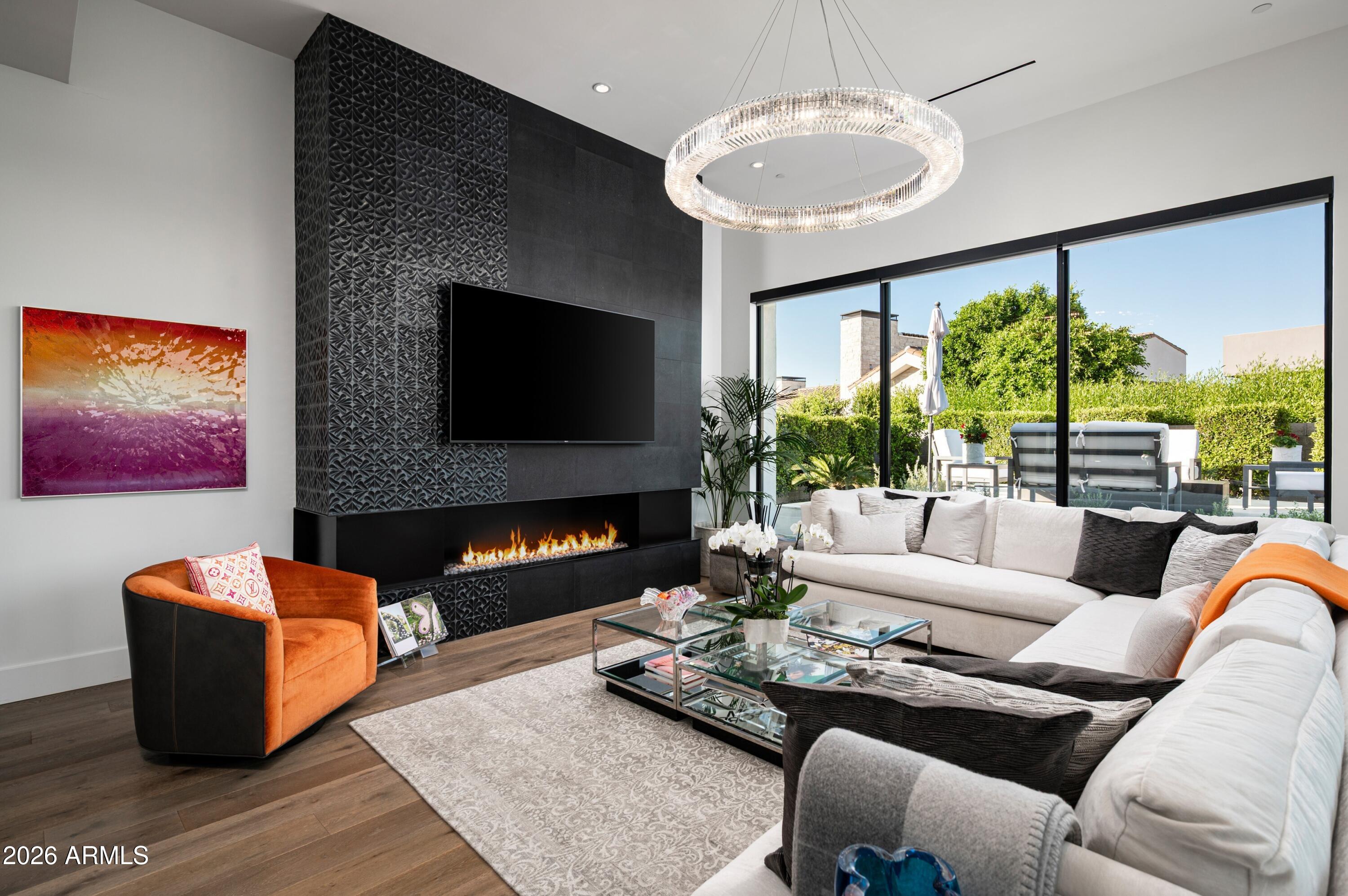 6914 East Cactus Wren Road Paradise Valley, AZ 85253 - Photo 14 of 38 a living room with furniture fireplace and a large window