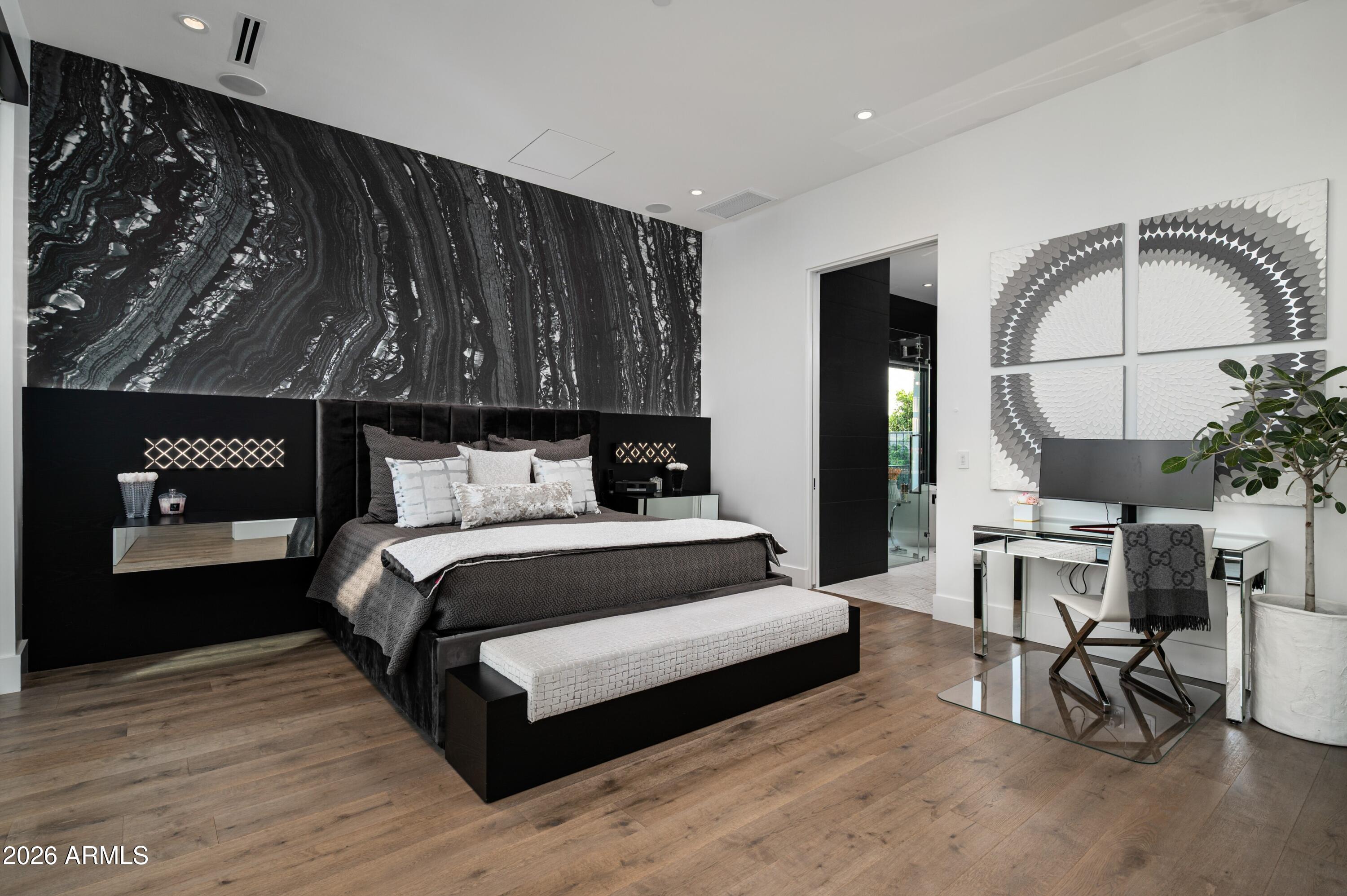 6914 East Cactus Wren Road Paradise Valley, AZ 85253 - Photo 16 of 38 a bedroom with a bed a mirror and paintings on the wall