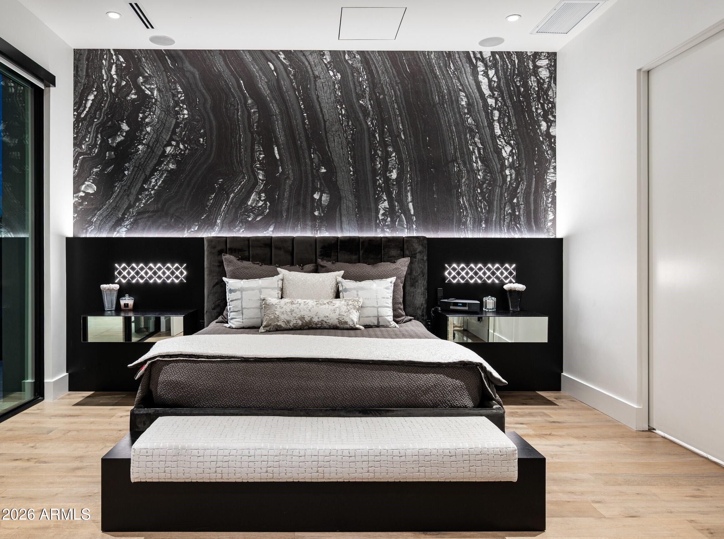 6914 East Cactus Wren Road Paradise Valley, AZ 85253 - Photo 18 of 38 a bedroom with a bed and wooden floor