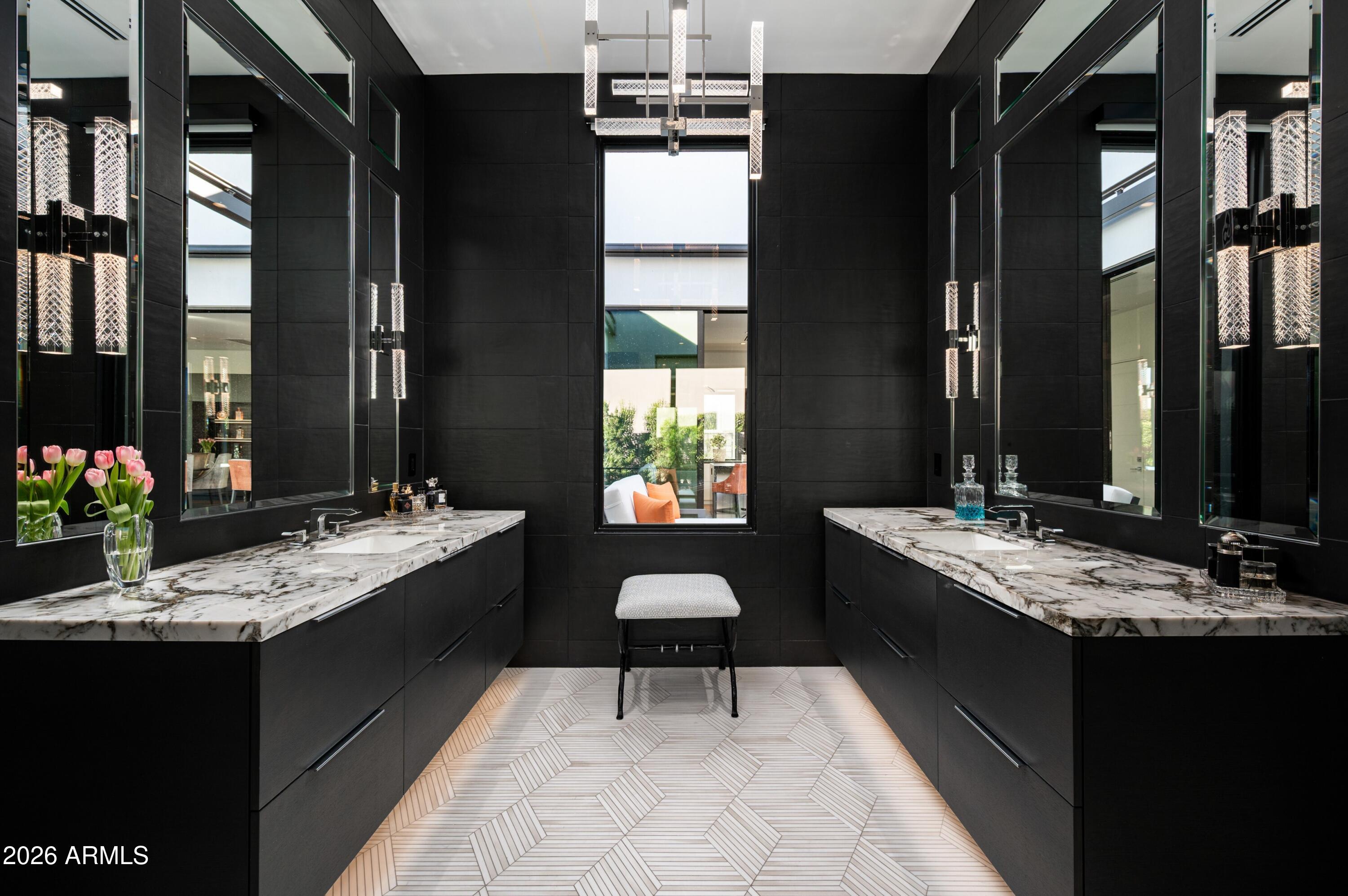6914 East Cactus Wren Road Paradise Valley, AZ 85253 - Photo 19 of 38 a bathroom with a granite countertop sink a large mirror and a bathtub