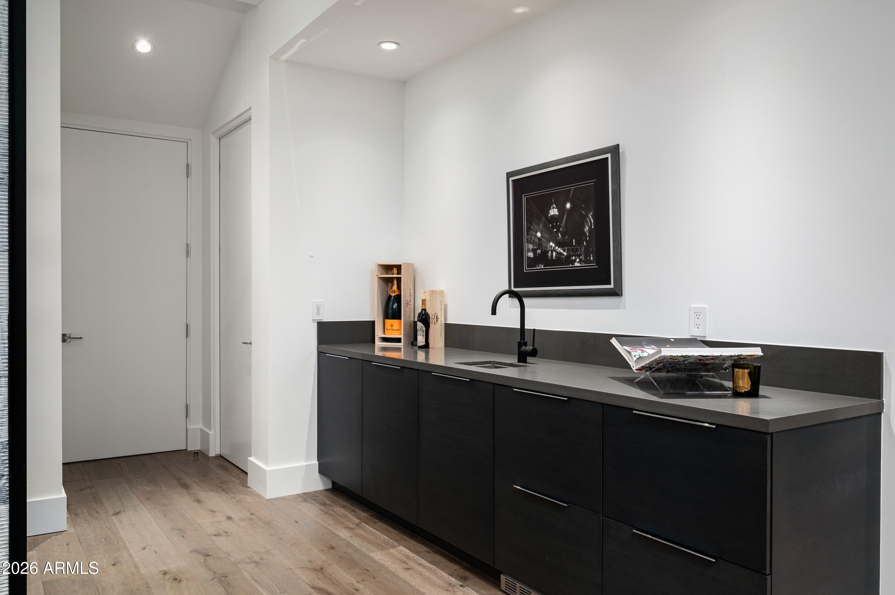 6914 East Cactus Wren Road Paradise Valley, AZ 85253 - Photo 25 of 38 a kitchen with a sink and cabinets