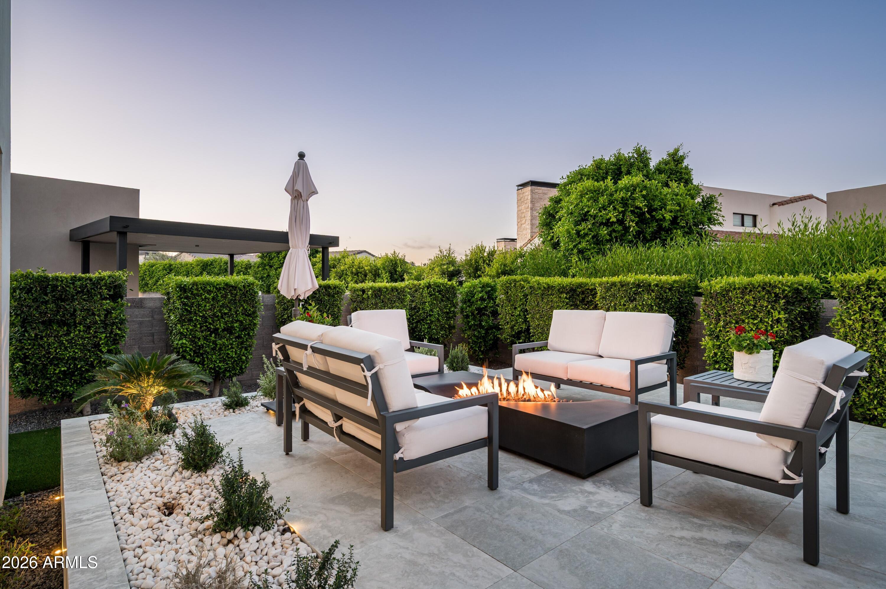 6914 East Cactus Wren Road Paradise Valley, AZ 85253 - Photo 28 of 38 a view of a patio with a table and chairs