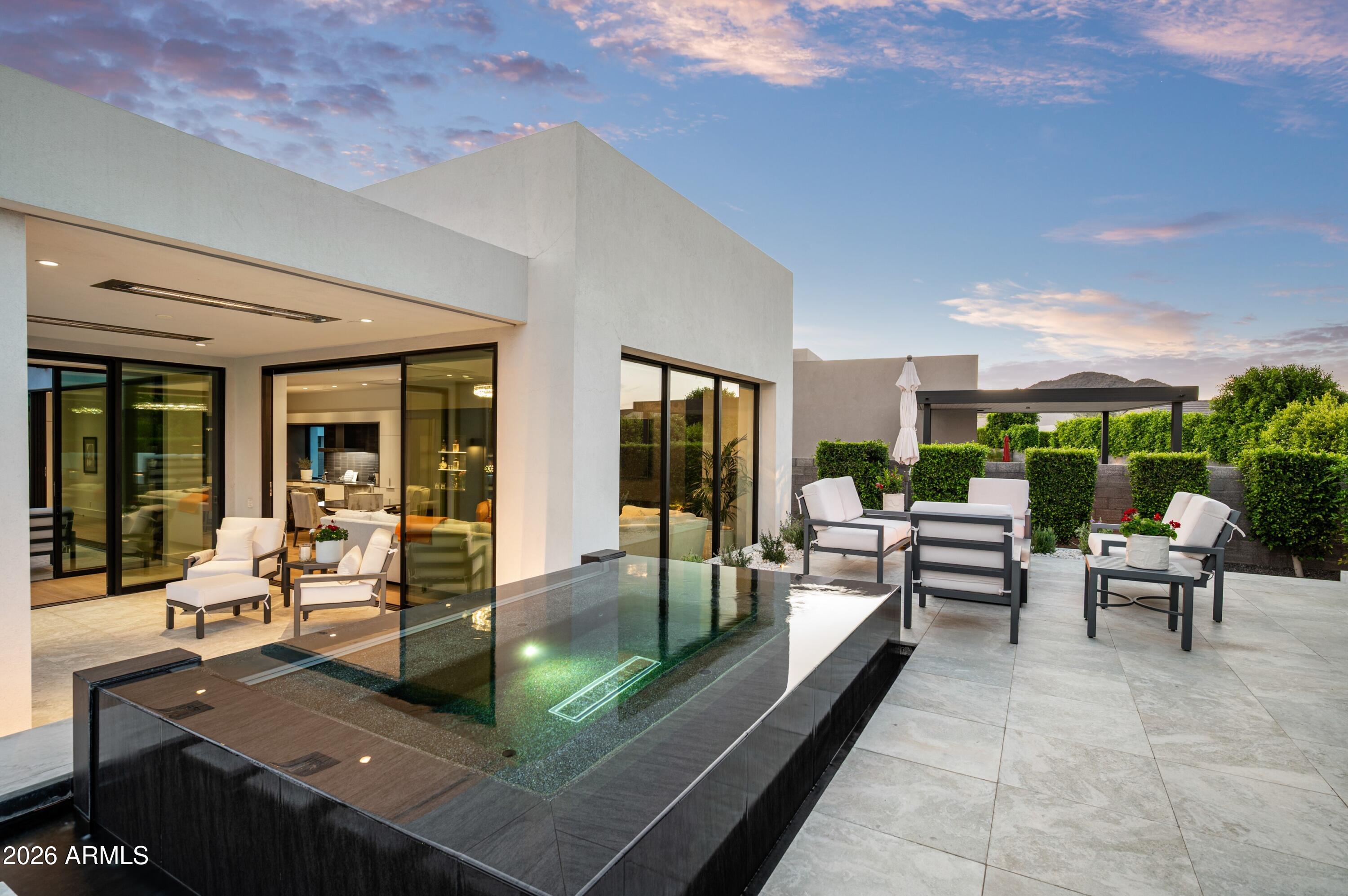 6914 East Cactus Wren Road Paradise Valley, AZ 85253 - Photo 31 of 38 a view of a patio with couches table and chairs and potted plants