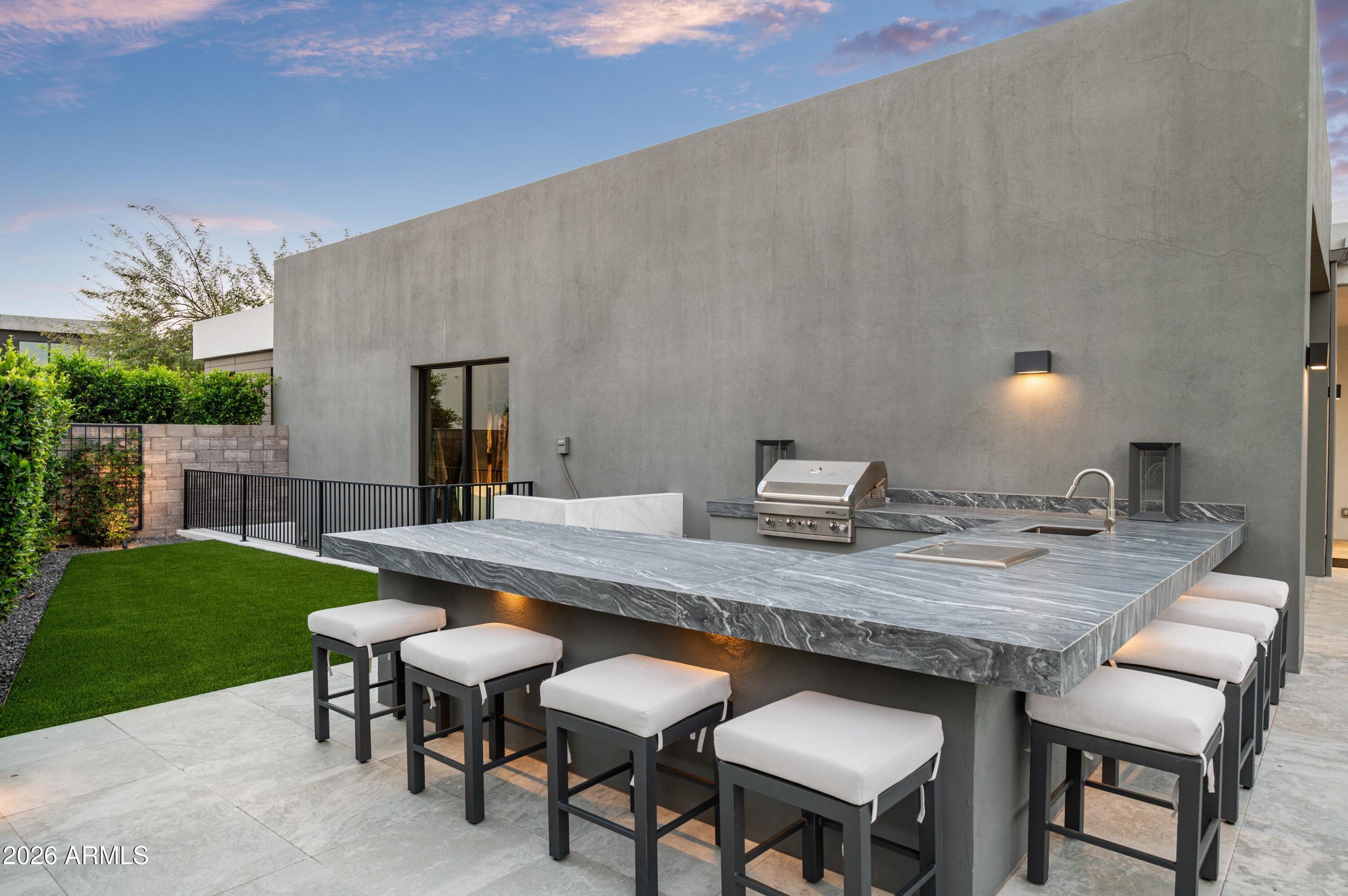 6914 East Cactus Wren Road Paradise Valley, AZ 85253 - Photo 32 of 38 a view of a dinning table and chairs in backyard