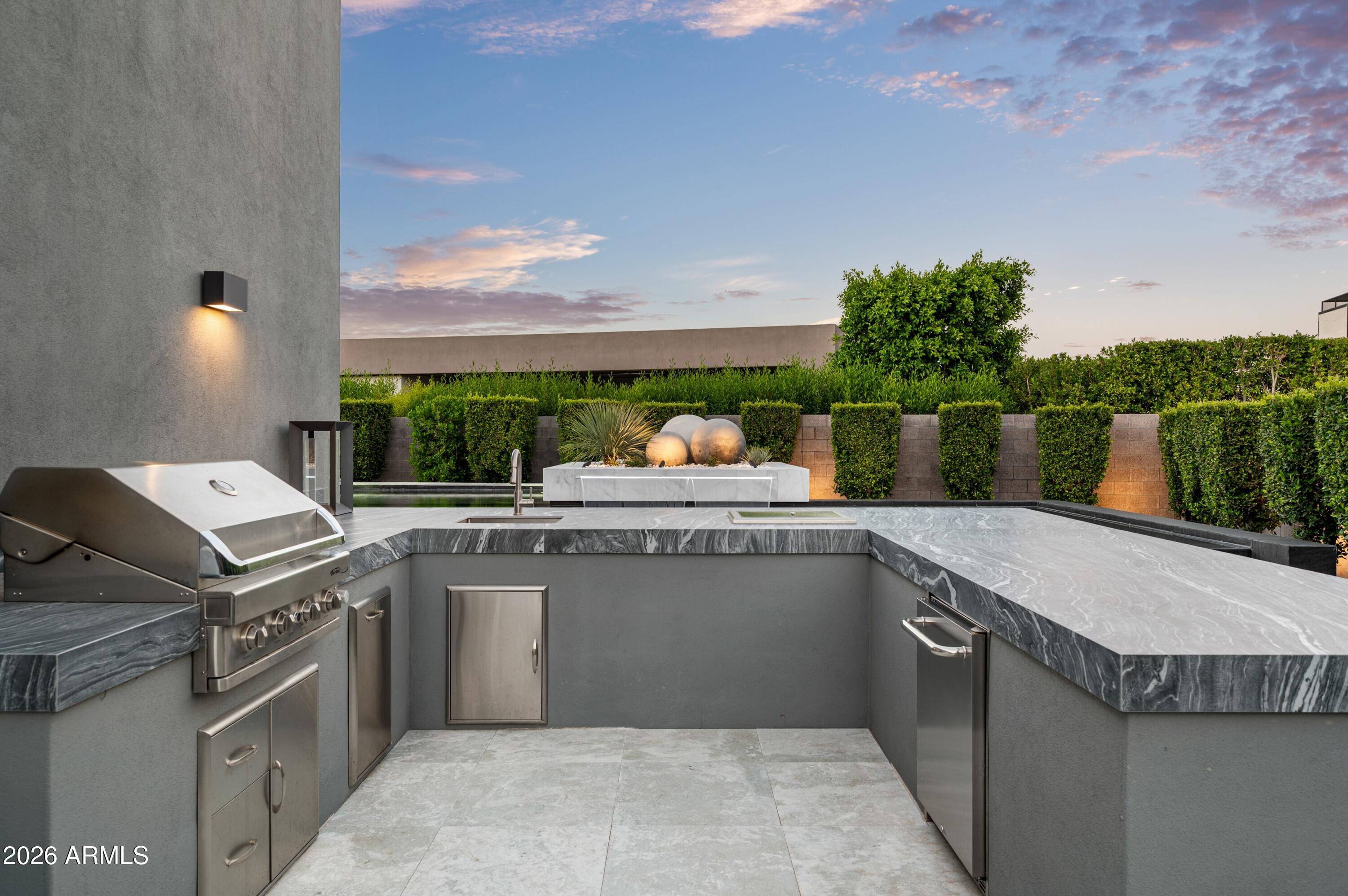 6914 East Cactus Wren Road Paradise Valley, AZ 85253 - Photo 33 of 38 a open kitchen with a sink and dishwasher with wooden floor