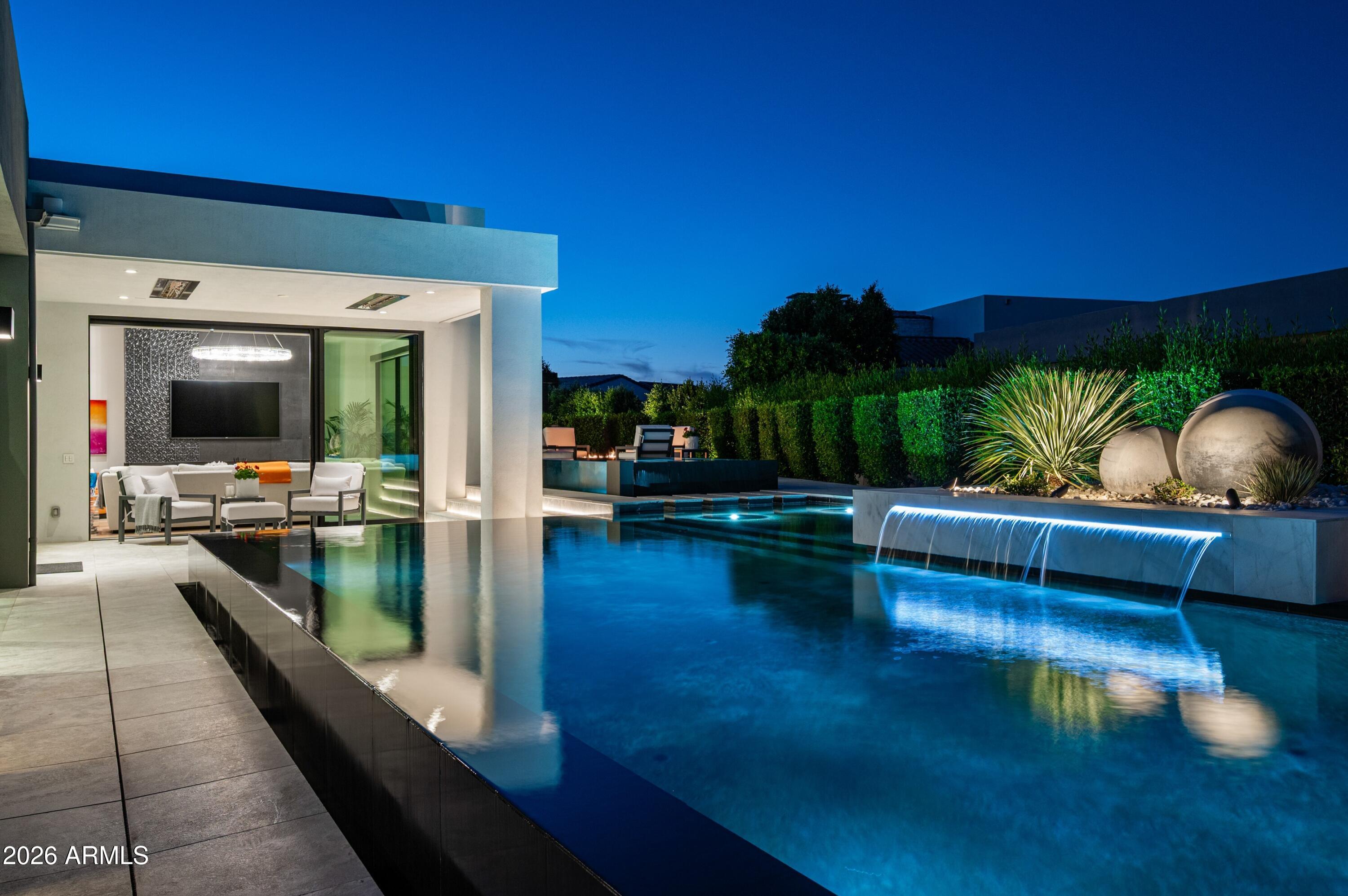 6914 East Cactus Wren Road Paradise Valley, AZ 85253 - Photo 35 of 38 a living room with furniture and a flat screen tv