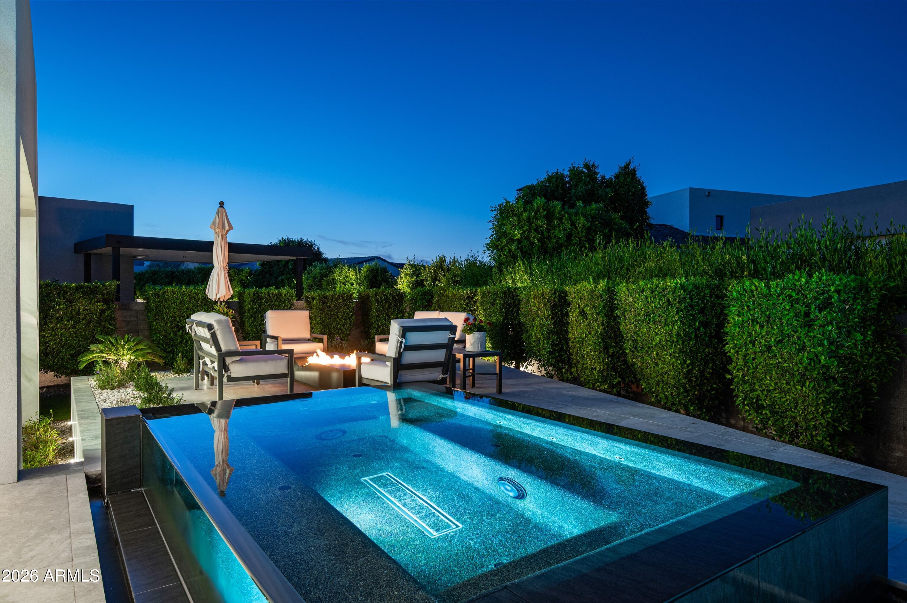 6914 East Cactus Wren Road Paradise Valley, AZ 85253 - Photo 36 of 38 a view of a chairs and table in patio with wooden fence