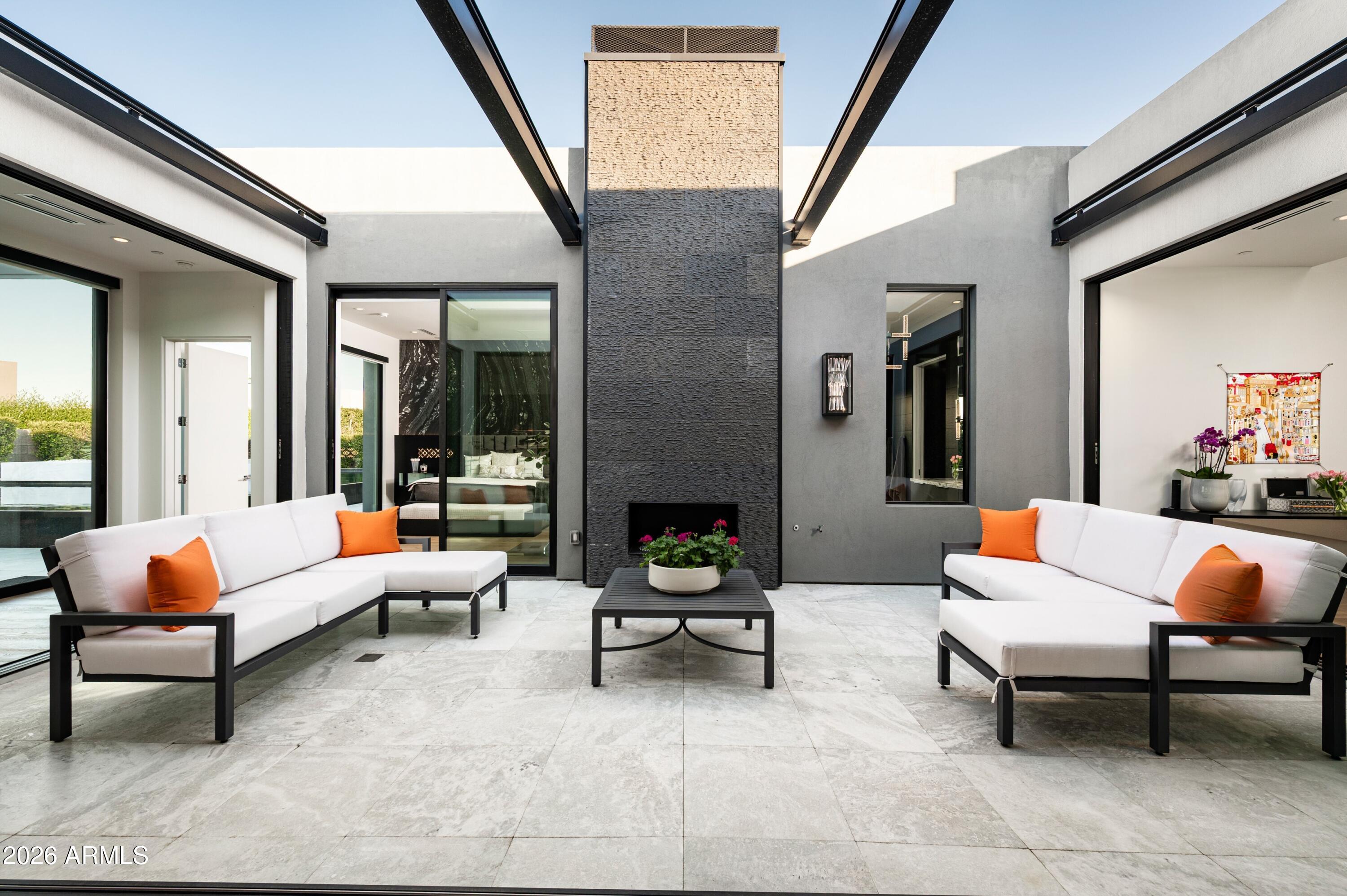 6914 East Cactus Wren Road Paradise Valley, AZ 85253 - Photo 7 of 38 a outdoor living space with furniture and a fireplace