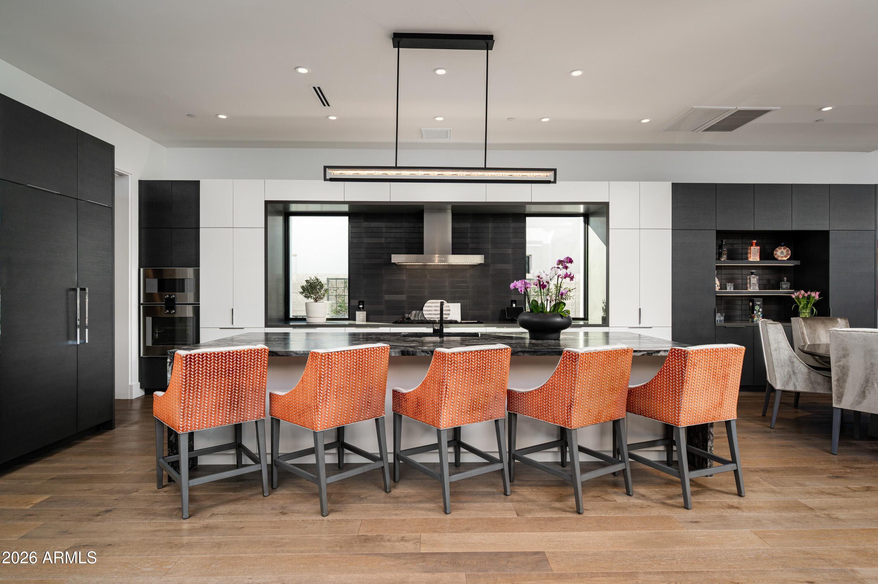 6914 East Cactus Wren Road Paradise Valley, AZ 85253 - Photo 8 of 38 a large kitchen with a table and chairs