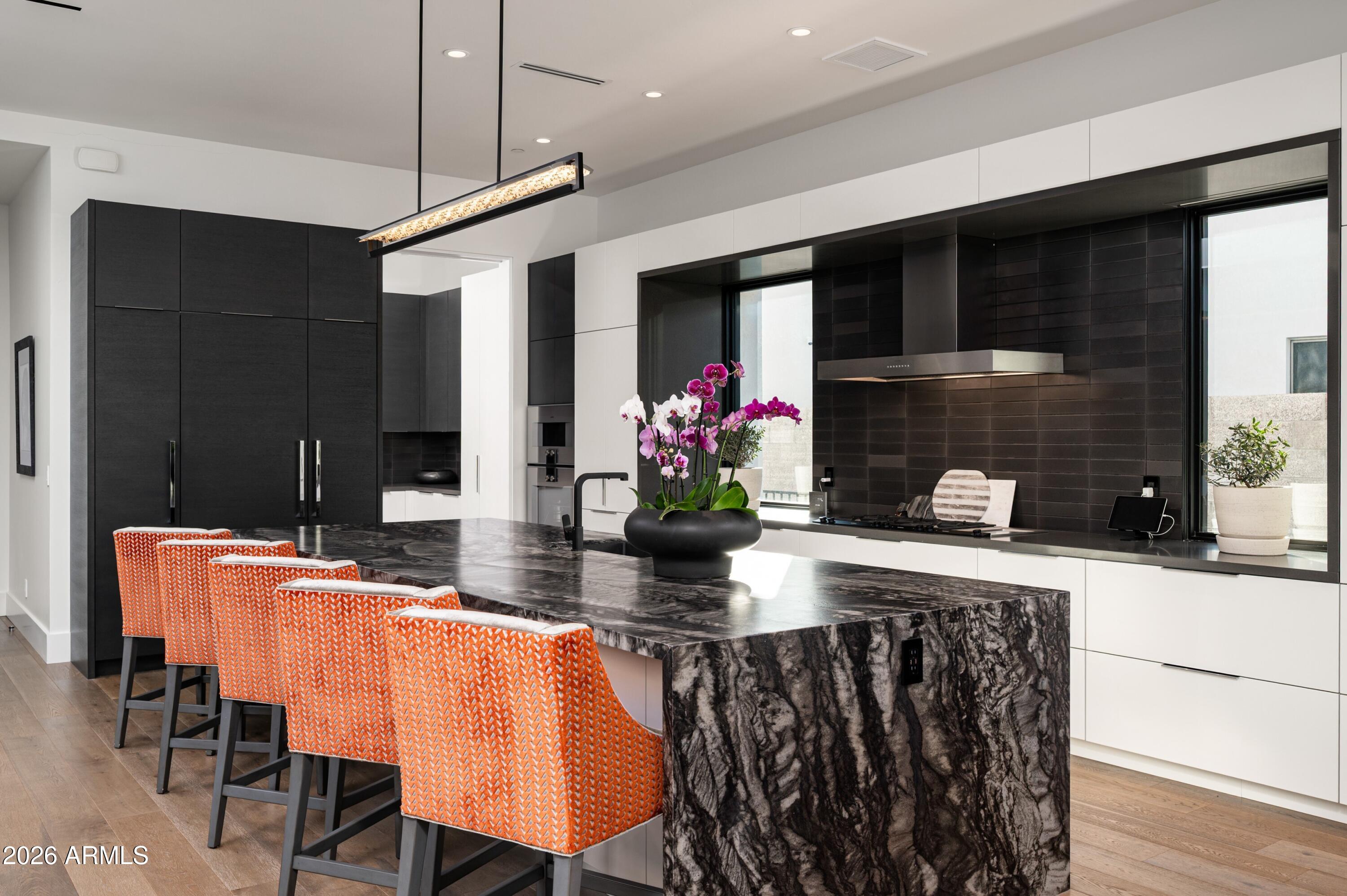 6914 East Cactus Wren Road Paradise Valley, AZ 85253 - Photo 9 of 38 a view of a dining room with furniture window and wooden floor