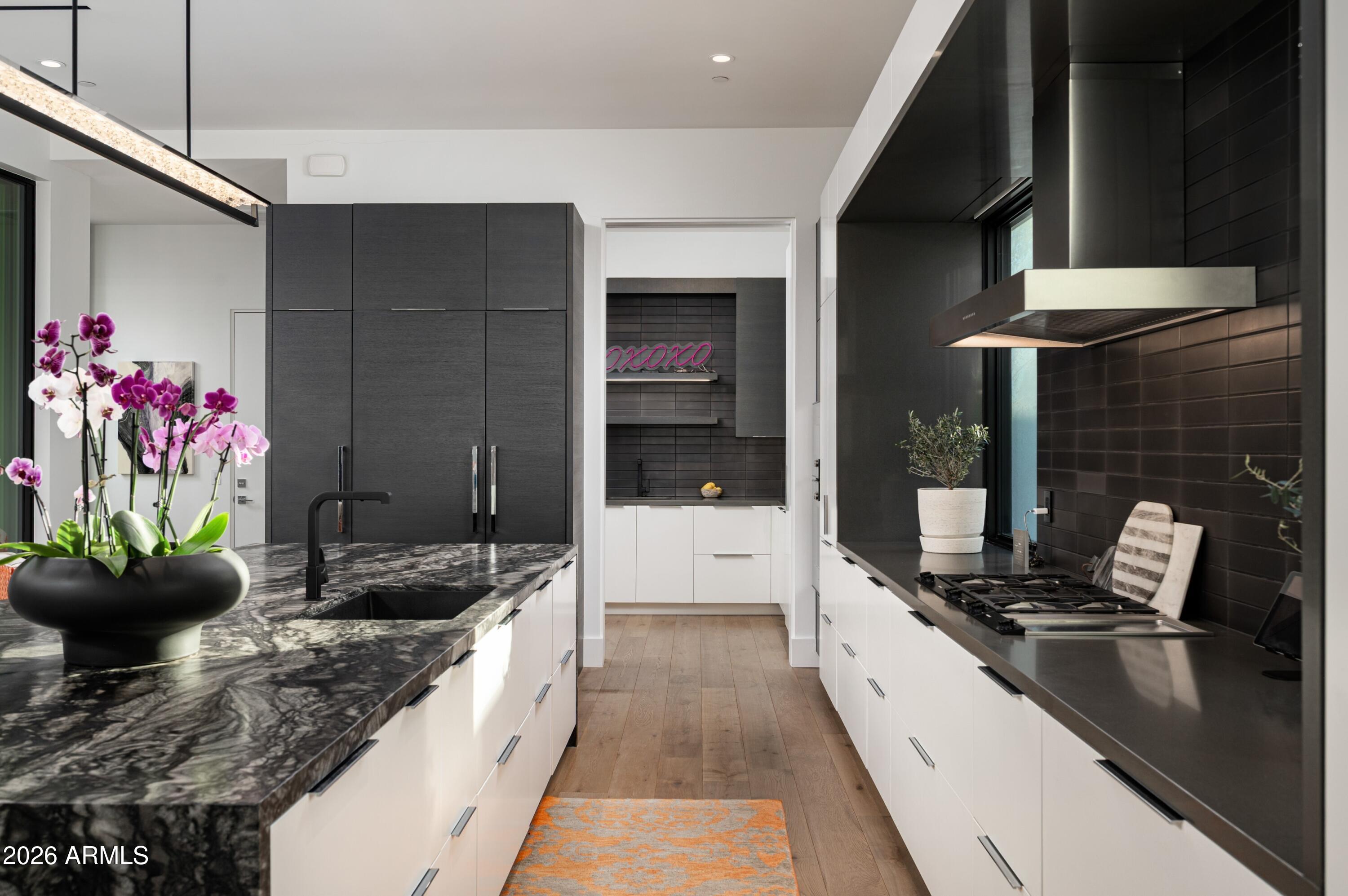 6914 East Cactus Wren Road Paradise Valley, AZ 85253 - Photo 10 of 38 a large kitchen with stainless steel appliances kitchen island granite countertop a sink and cabinets