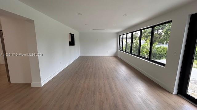 2825 Southwest 79th Court Miami, FL 33155 - Photo 18 of 20 an empty room with wooden floor and windows