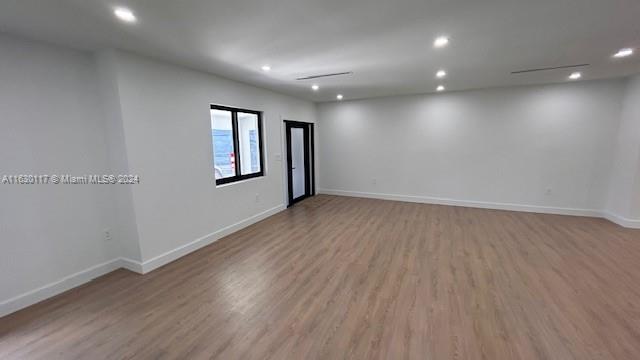 2825 Southwest 79th Court Miami, FL 33155 - Photo 4 of 20 an empty room with wooden floor and windows