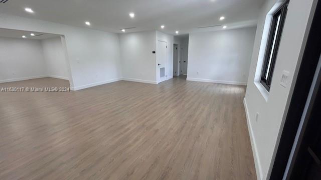 2825 Southwest 79th Court Miami, FL 33155 - Photo 6 of 20 an empty room with wooden floor and windows