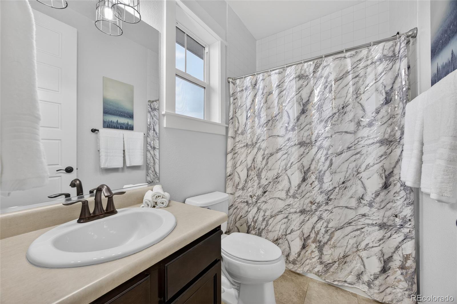 20554 East Shady Ridge Road Parker, CO 80134 - Photo 28 of 49 a bathroom with a granite countertop sink and a mirror