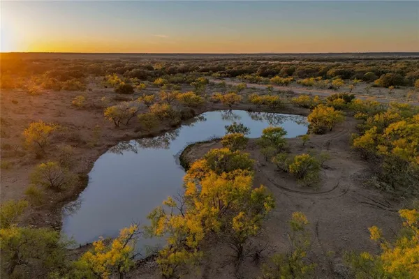an aerial view of ocean with residential houses with outdoor space