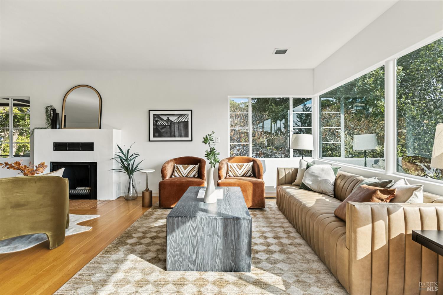 a living room with fireplace furniture and a large window