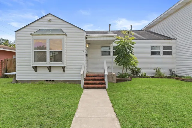 a front view of a house with a garden
