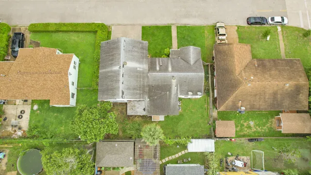 an aerial view of a house with outdoor space pool seating area and yard