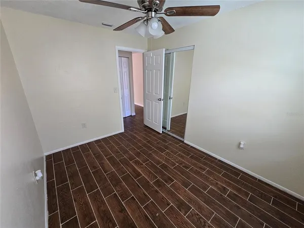 a view of a room with wooden floor