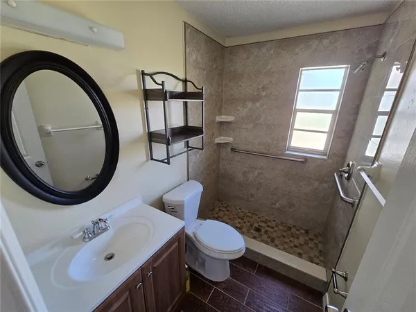 a bathroom with a sink a toilet and a mirror