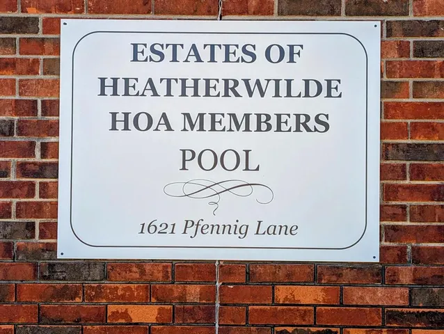 an aerial view of a house with a yard and trees