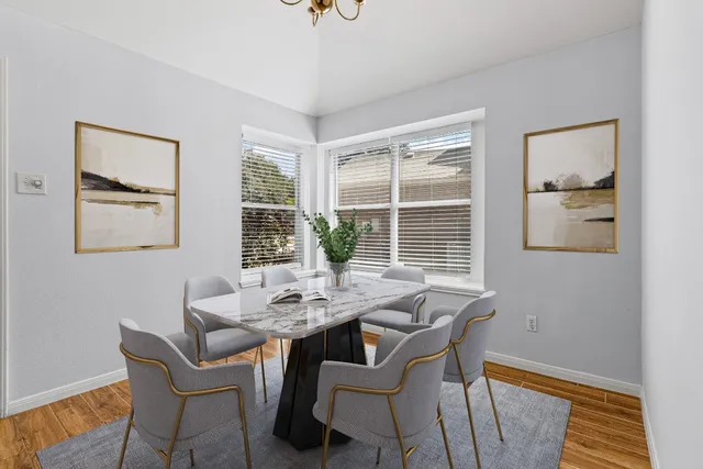 a dining room with furniture and window