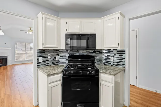 a kitchen with stainless steel appliances a stove a microwave and cabinets