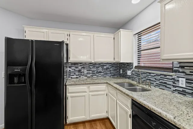 a kitchen with a sink and cabinets