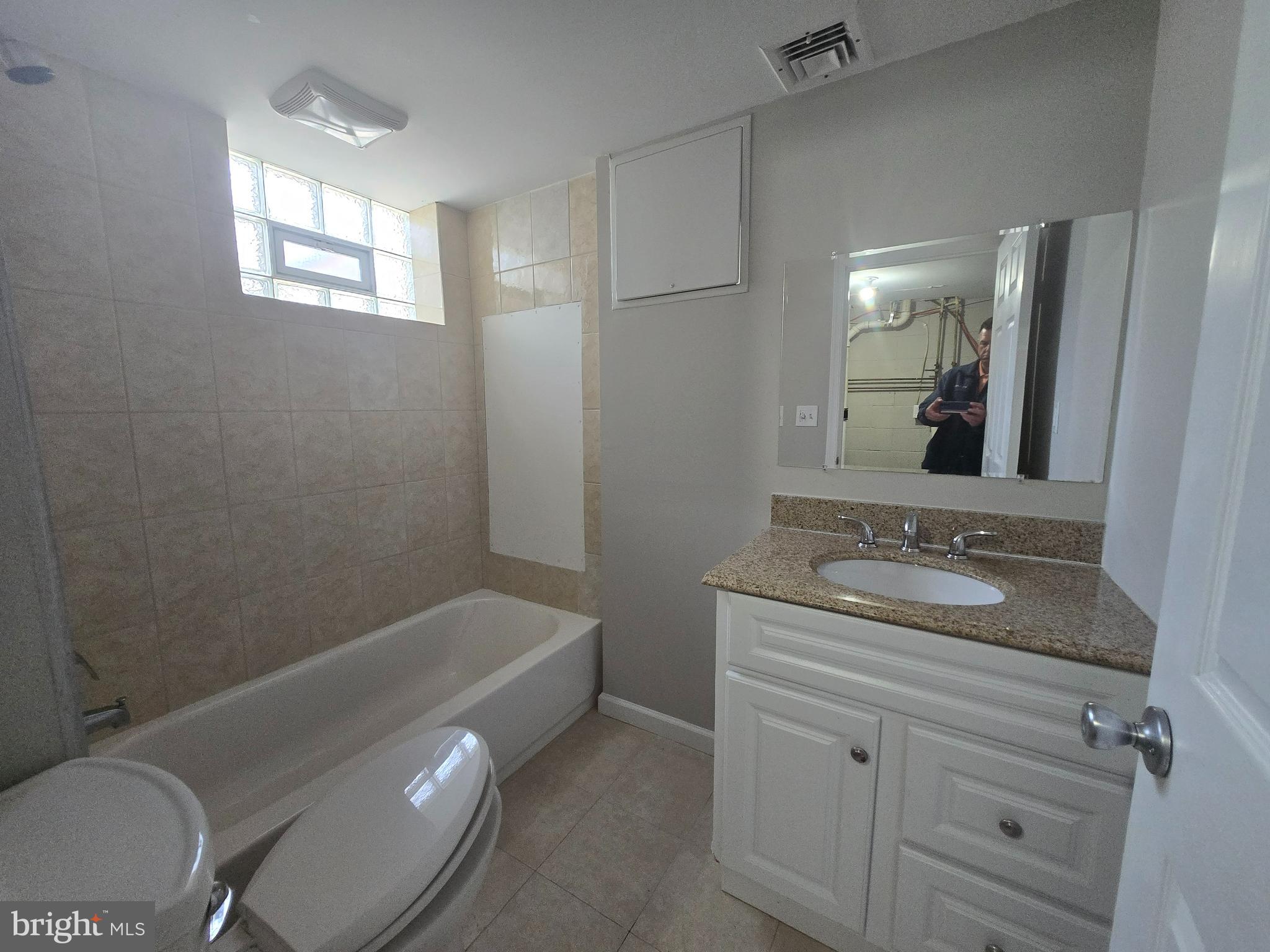 803 North Marlyn Avenue Baltimore, MD 21221 - Photo 16 of 22 a bathroom with a granite countertop sink toilet and shower