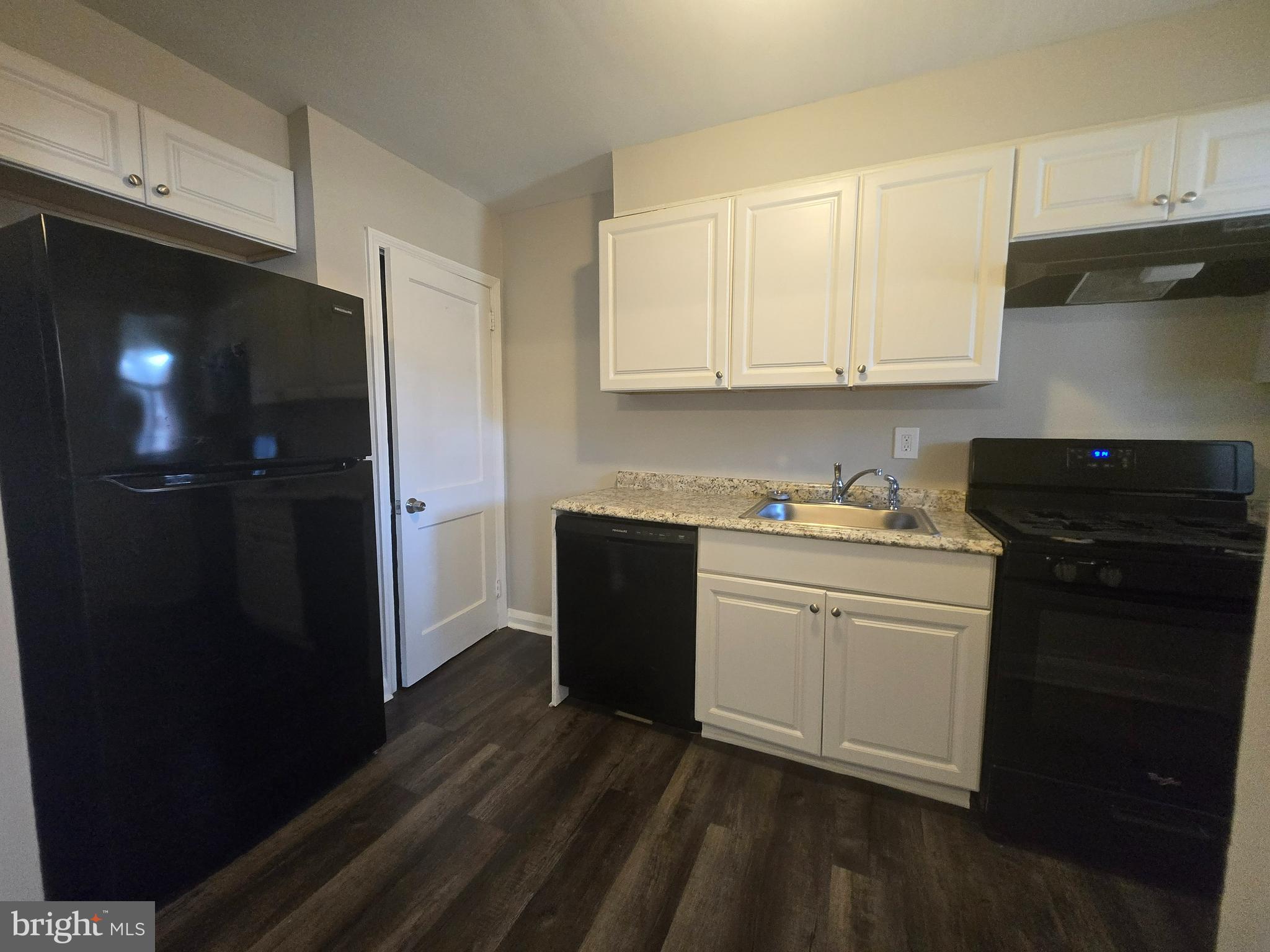 803 North Marlyn Avenue Baltimore, MD 21221 - Photo 6 of 22 a kitchen with a refrigerator and cabinets