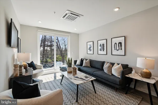 a living room with furniture and a large window