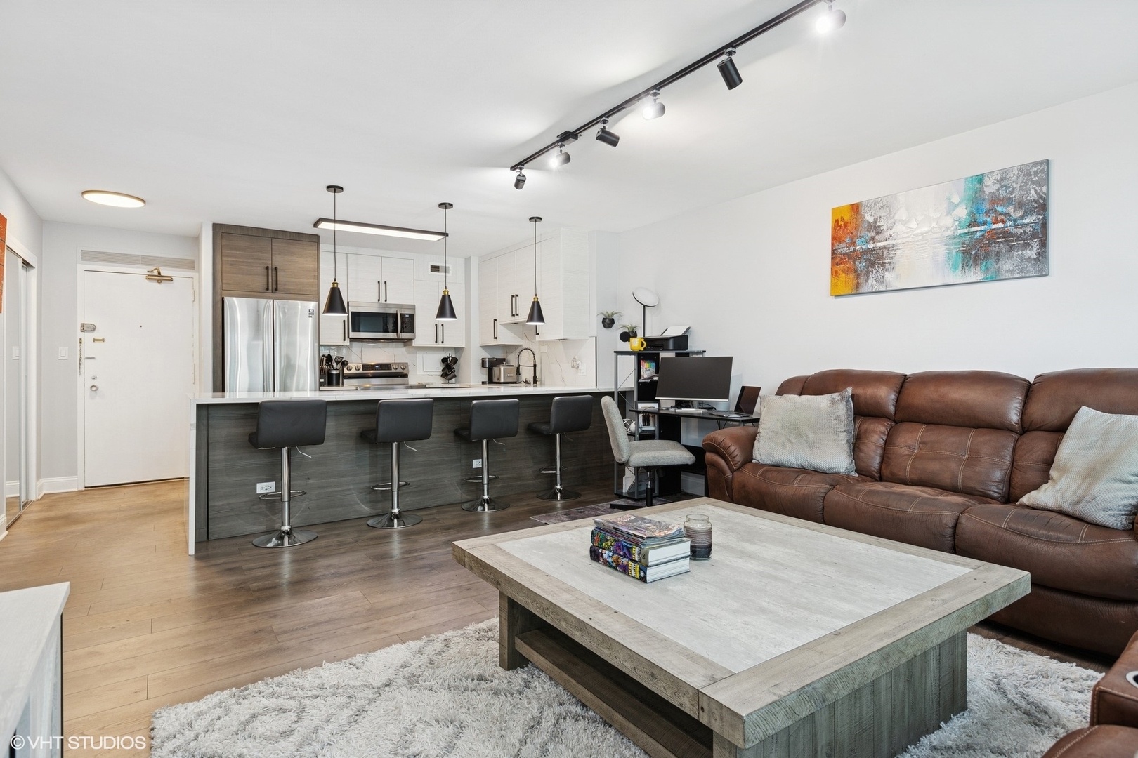3600 North Lake Shore Drive, Unit 1108 Chicago, IL 60613 - Photo 4 of 12 a living room with stainless steel appliances furniture a rug and a table