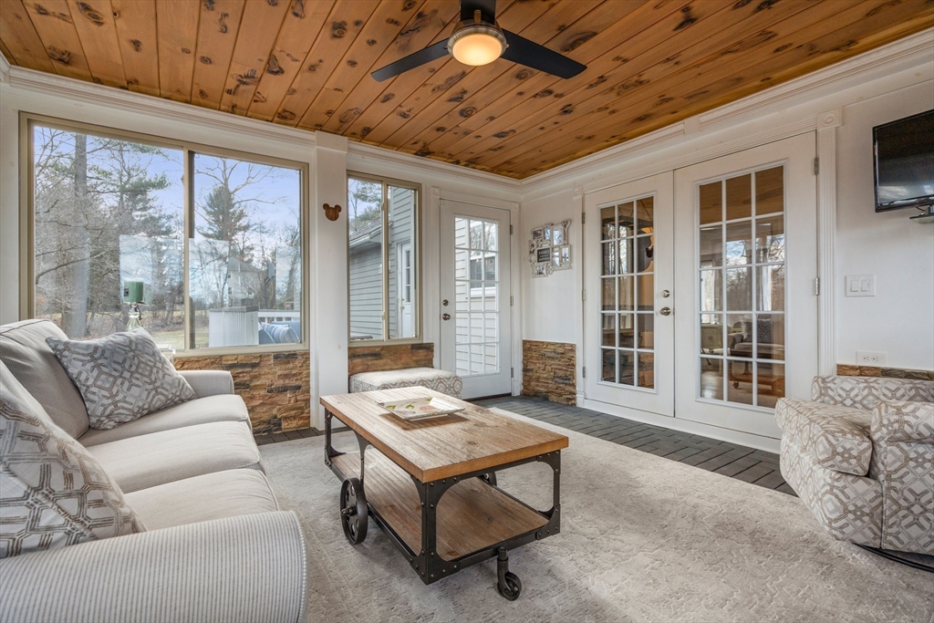 4 Greybirch Road Andover, MA 01810 - Photo 14 of 42 a living room with furniture a ceiling fan and a flat screen tv