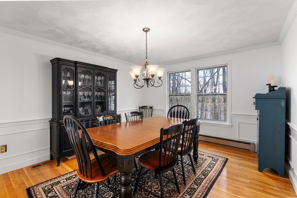 4 Greybirch Road Andover, MA 01810 - Photo 16 of 42 a dining room with furniture a chandelier and wooden floor