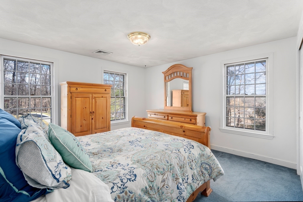 4 Greybirch Road Andover, MA 01810 - Photo 27 of 42 a bedroom with a bed and wooden floor