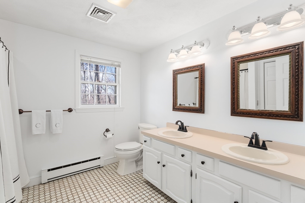 4 Greybirch Road Andover, MA 01810 - Photo 30 of 42 a bathroom with a granite countertop sink mirror and a toilet